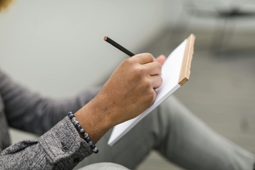 person writing on laptop