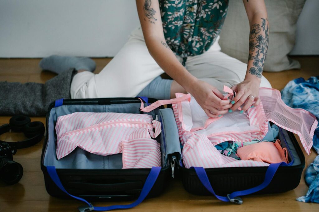woman packing suitcase cheerfully